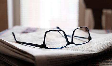 Glasses on the newspaper